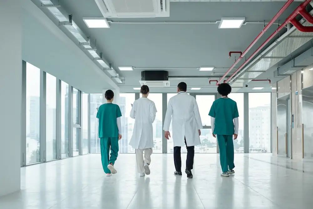 colleagues-walking-along-the-corridor-in-hospital
