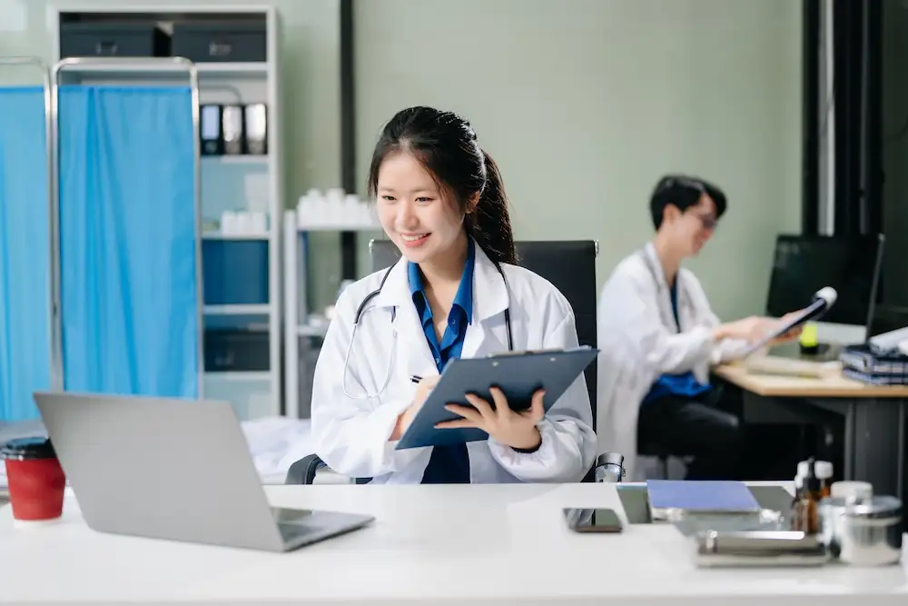 friendly-doctor-looks-at-laptop-in-office-2026-01-05-23-25-18-utc